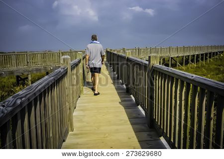 This Person Uses A Pedestrian Crossing Made Of Wood To Protect The Shoreline. It Was Sunny. South Pa