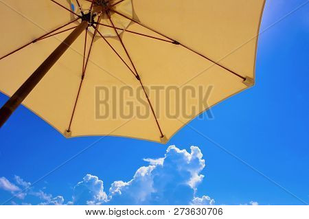 Umbrella From The Sun Against The Blue Sky