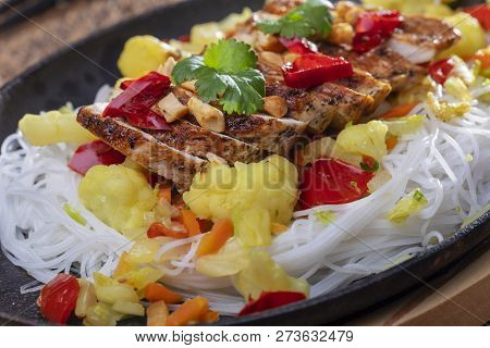 Closeup Of A Steaming Hot Sizzler On Wood