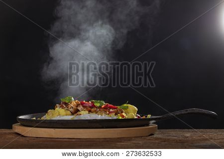 Steaming Hot Sizzler On Wood With Smoke