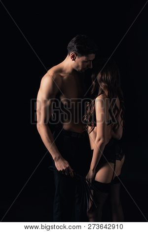 Undressed Couple Holding Leather Flogging Whip Isolated On Black