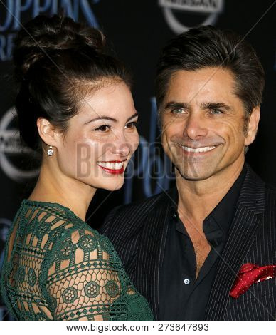 Caitlin Mchugh and John Stamos at the World premiere of Disney's 'Mary Poppins Returns' held at the Dolby Theatre in Hollywood, USA on November 29, 2018.