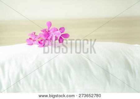 Pillows And Beautiful Orchid Flower On Top In The Bed Room.