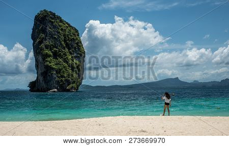 Teen Girl Standing On Tropical Beach In Thailand Looking At Island