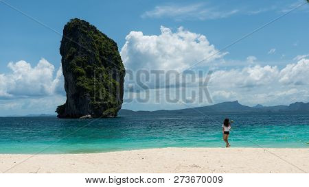 Teen Girl Standing On Tropical Beach In Thailand Looking At Island