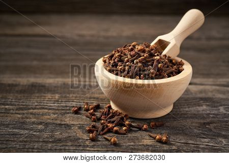 Cloves On A Gray Wooden Background.dried Cloves In A Wooden Bow
