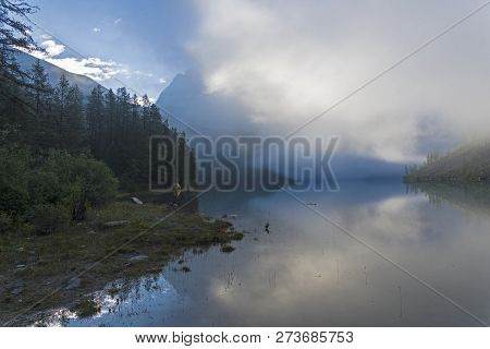 The Clouds Lie On The Surface Of The Lake. A Misty Summer Morning. The Large (lower) Shavlinsky Lake