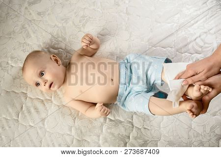 Care For Babe Momy Wiping The Baby Skin With Wet Wipes. Cleaning Wipe, Pure, Clean Little Baby Feet.