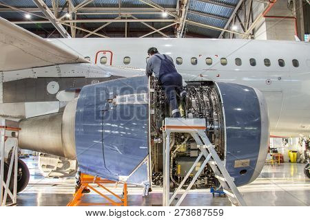 Mechanic Specialist Repairs The Maintenance Of Engine Of A Passenger Aircraft In A Hangar