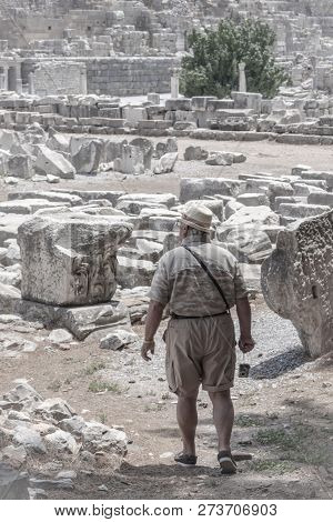Tourist Man Is Walking In The Ancient City Of Ephesus (turkey), Apreciating The Antique Architecture