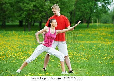 Personal training. fitness instructor exercising woman outdoors