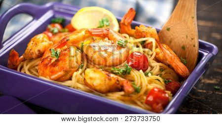 Stir-fried Spaghetti With Grilled Shrimps And Tomatoes - Italian Fusion Food Style.