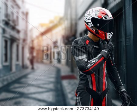 Krasnoyarsk, Russia - May 30, 2018: A Motorcyclist In Full Gear And Helmet Stands In The Middle Of T
