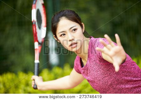 Young Asian Woman Female Tennis Player Hitting Ball With Forehand