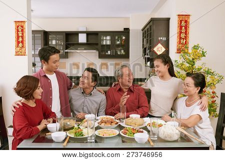 Big Vietnamse Family Enjoying Traditional Dinner And Celebrating Lunar New Year, Couplets With Best 