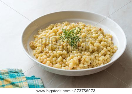 Cooked Couscous With Dill Served In White Plate / Turkish Kuskus