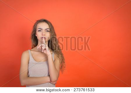 Lips And Hand Of Beautiful Young Girl Doing Silence Sign Tss Gesture Isolated On Red Background With