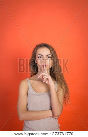 Lips And Hand Of Beautiful Young Girl Doing Silence Sign Tss Gesture Isolated On Red Background With