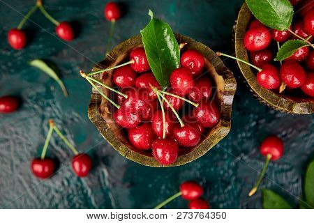 Red Cherry In Bowl On Green Background. Summer Or Spring Concept.