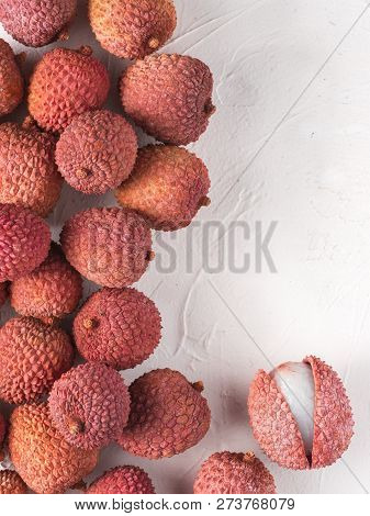 Lichee Fruit On White Textured Background. Lichee Wit Copy Space. Top View Or Flat Lay. Vertical