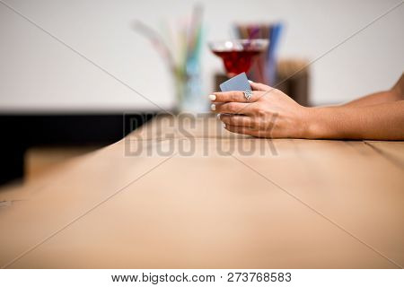 Close Up Of Girl Hand Wearing Nive Ring And Holding Credit Card. Going To Pay In Cafe.