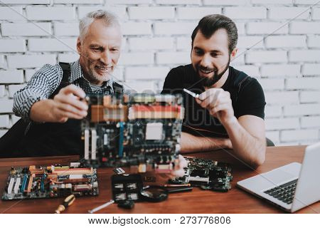 Two Men Repairing Hardware Equipment From Pc. Repair Shop. Worker With Tools. Computer Hardware. You