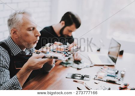 Two Men Repairing Hardware Equipment From Pc. Repair Shop. Worker With Tools. Computer Hardware. You