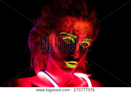 Portrait Of A Beautiful Young Sexy Girl In Neon Lent With Ultraviolet Paint On Her Body. Pretty Woma