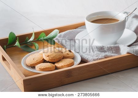 Closeup Of Coffee With Milk In White Cup And Tasty Cookies. Shot On Light Stone Background