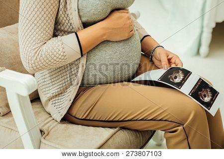 Pregnant Woman Looking At Her Ultrasound Scan