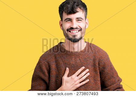 Young handsome man wearing winter sweater over isolated background Smiling and laughing hard out loud because funny crazy joke. Happy expression.