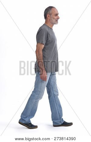 A Middle-aged Man Walking On White Background