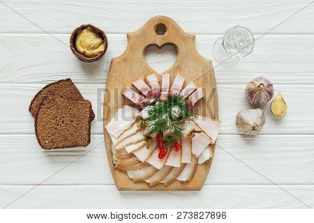 Traditional Sliced Smoked Lard On Cutting Board With Mustard, Glass Of Vodka And Rye Bread On White 