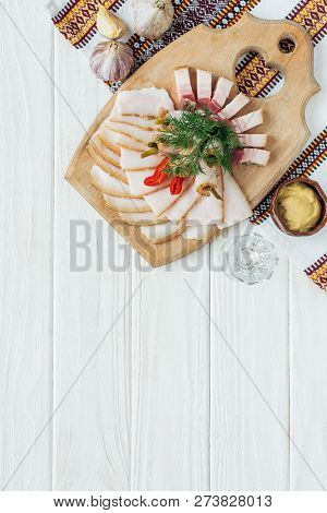 Traditional Sliced Smoked Lard On Cutting Board With Mustard, Embroidered Towel And Glass Of Vodka O