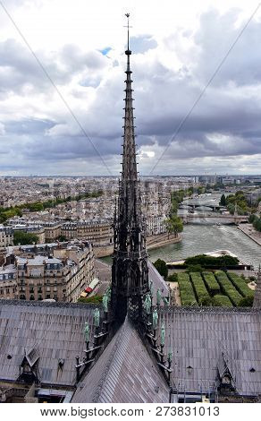 Notre Dame Cathedral, Paris, France. Spire (La Fleche) and Apostles, Seine river and cityscape from towers viewpoint.