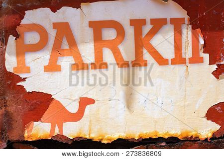 Old Worn Out Parking Sign In The Sahara Desert At Ksar Ghilane, Tunisia