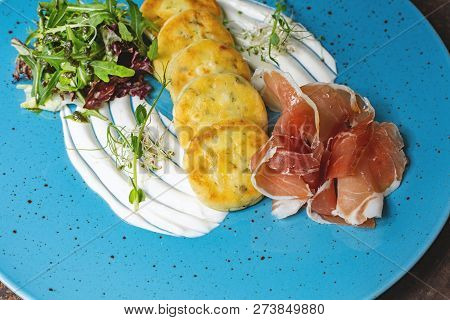 Potato Pancakes With Bacon On Blue Plate