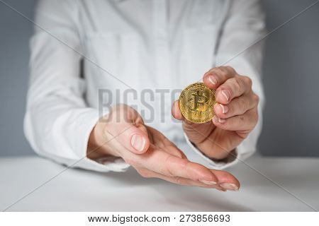 Golden Bitcoin In A Man Hand, Digitall Symbol Of A New Virtual Currency