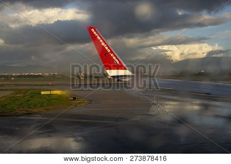 Rain And Sunshine Effects Through Window With Red Norwegian Airplane Wing