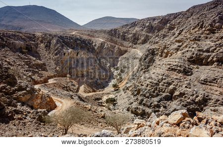 Twisty dirt road in the mountains of Al Hajar in Fujairah, UAE