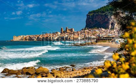 Panoramic View Of Cefalu City With Traditional Houses On The Seaside And Famous Beach In A Sunny Day
