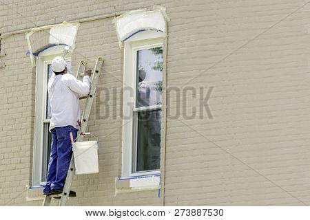 The Painter Paints Window Frames With White Paint