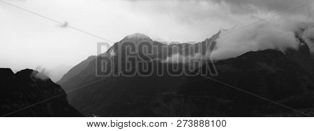 Panoramic View Of A Mountain Range With Clouds