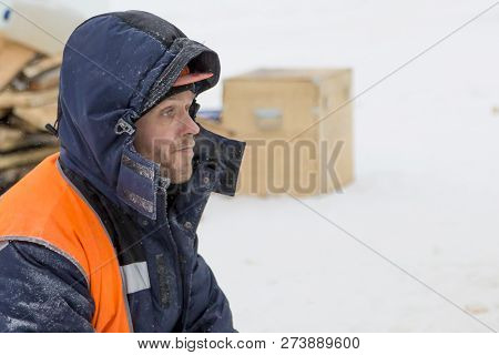 Worker Fitter In A Protective Helmet And Reflective Vest On The Working Meast
