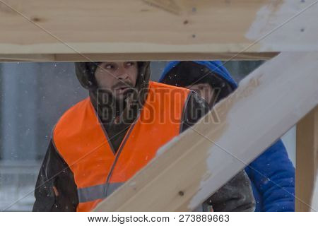 Worker Fitter In A Protective Helmet And Reflective Vest On The Working Meast