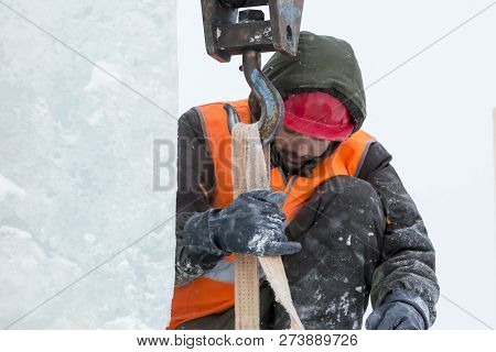 Worker Fitter In A Protective Helmet And Reflective Vest On The Working Meast