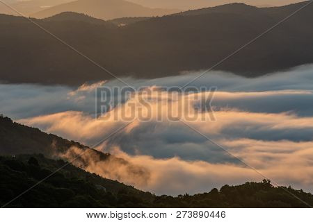 Whispy Clouds Cling To The Blue Ridge Mountains