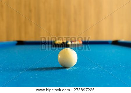 Billards Pool Game. White Ball On Spot With Set Colours Ball In Background On Blue Table.