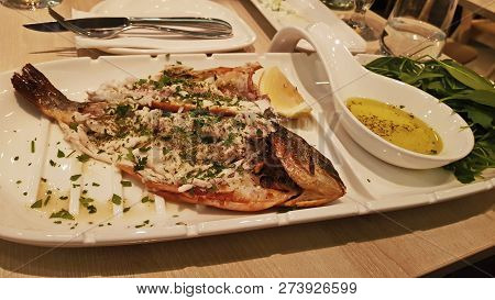 Fried Fish With Seasoning On A White Plate