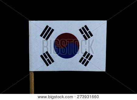 A Unique Flag Of South Korea On Toothpick On Black Background. A White Field With A Red And Blue Tae
